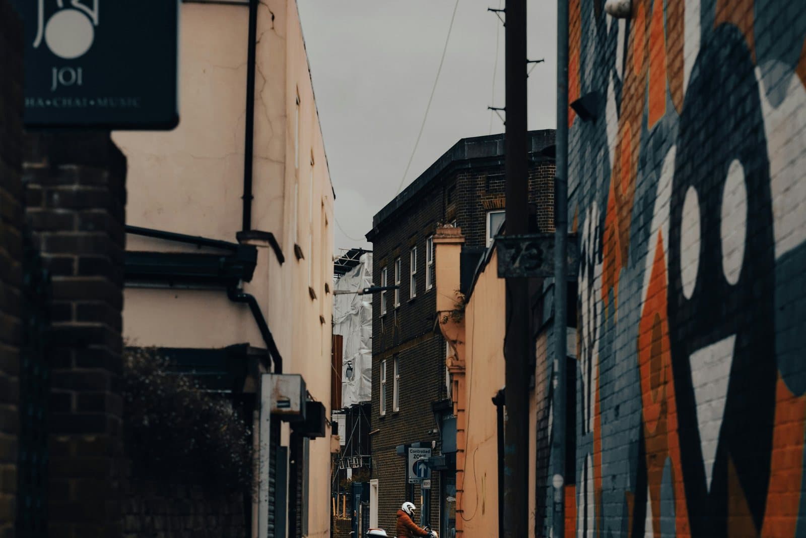 A Southsea back alley with an independent shopfront sign and street art